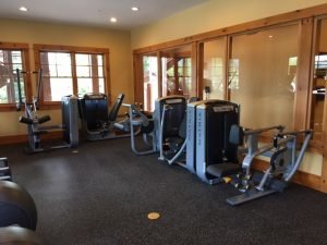 A glass enclosed room with Matrix strength training equipment