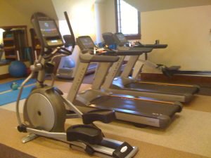 Two Matrix treadmills and an elliptical in a smaller room