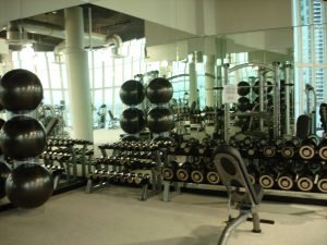 Workout balls in a mirrored room with strength training weights