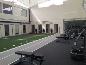 A domed fitness center with fitness equipment off to one side