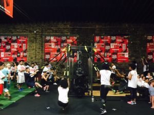 A group of men and women using a weight machine