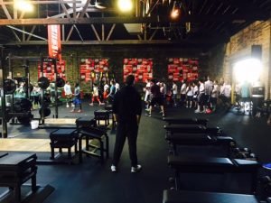 Athletes entering a room filled with fitness equipment