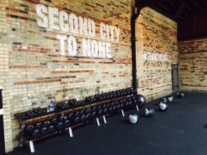 Weights sitting underneath a wall that says "Second City To None"