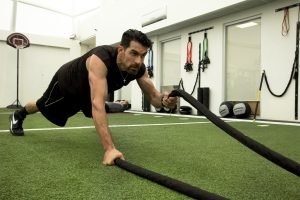 A man doing a workout routine on indoor fake grass